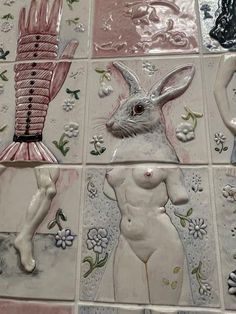 some ceramic artwork on a tiled wall