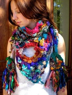 a woman wearing a multicolored crocheted scarf