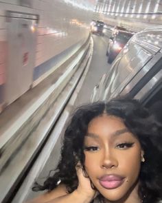 a woman is taking a selfie on the subway