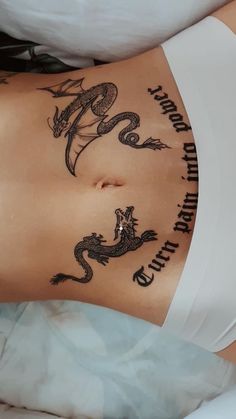 a woman with a dragon tattoo on her stomach