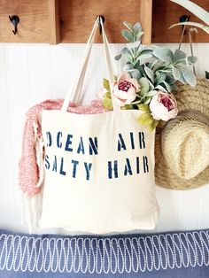 The OCEAN AIR SALTY HAIR over sized canvas tote bag is an eye catching accessory for your relaxing vacation!  It makes a great gift and is perfect for a trip to the grocery store or market, to use as a beach bag, or everyday carryall.  Available with text in several colors... check out the variations!  This bag is made from 100% thick, sturdy canvas. AVAILABLE IN TWO SIZES * Large - 19.5" x 13" with a 4" gusset *Jumbo - 23" x 13" with a 6" gusset   These bags are hand painted using non-toxic fab Large Capacity Cotton Beach Bag For Travel, Trendy Summer Bags For Weekend Trips, Trendy Bags For Weekend Trips In Summer, Cotton Bags For Weekend Trips In Summer, Cotton Bags For Weekend Trips During Summer, Cotton Beach Bag For Everyday Use On Vacation, Cotton Beach Bag For Travel And Vacation, Large Capacity Cotton Beach Bag For Vacation, Cotton Tote Bag For Vacation