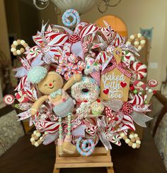 an arrangement of candy, donuts and other items is displayed in the center of a table