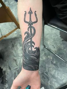 a woman's arm with a tattoo on it and an anchor in the middle