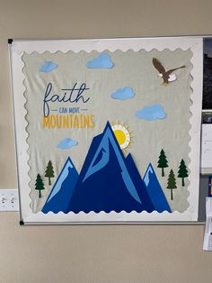 a bulletin board on the wall with mountains and an eagle flying over it that says faith can move mountains