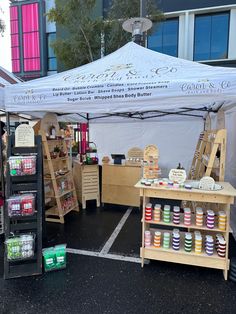 an outdoor market tent with various items for sale