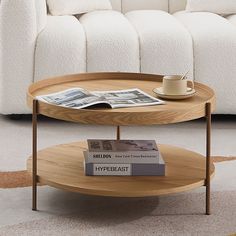 a coffee table with magazines and a cup on it