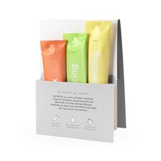 an open box with three different types of hand creams in it on a white background