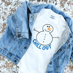 a snowman shirt and jean jacket laying on the ground