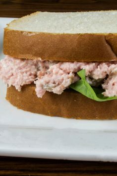 a close up of a sandwich on a plate with meat and lettuce in it