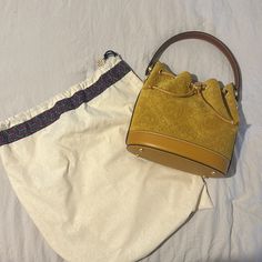 Brand New Slightly Used Tory Burch Bucket Bag. Color Is A True Mustard Yellow In A Suede Fabric Luxury Yellow Bucket Bag With Removable Pouch, Elegant Monogram Canvas Bucket Bag With Detachable Handle, Elegant Monogram Canvas Shoulder Bucket Bag, Elegant Yellow Bucket Bag With Top Handle, Elegant Monogram Canvas Bucket Bag With Removable Pouch, Elegant Yellow Top Handle Bucket Bag, Elegant Monogram Canvas Bucket Bag, Elegant Yellow Bucket Bag With Removable Pouch, Elegant Yellow Bucket Bag With Adjustable Strap