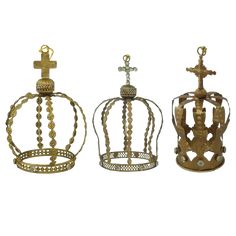 three metal crowns with crosses on them