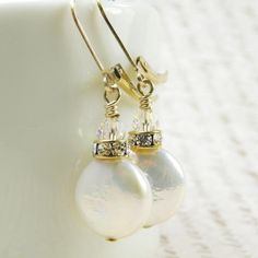 Beautiful pearl earrings are handmade with iridescent white coin pearls. Shaped liked little discs, these pearls are grown naturally from oysters seeded with a tiny disc shaped object. Perfect luster and polish on these coin pearl earrings. Accented with a Swarovski rhinestone crown and sparkly crystal. Dangles gracefully on 14k gold filled leverback earring closures.A great gift for a woman born in June since pearl is her birthstone.Earring Details:- Coin pearls are 12 mm- Pearl earrings are ju Handmade Pearl White Pearl Earrings, Round Pearl Pendant Earrings As Gift, Baroque Pearl Earrings Gift, Baroque Pearl Earrings For Gift, Pearl Drop Bridal Earrings For Celebrations, Pearl Drop Round Earrings For Celebration, Wedding Pearl Drop Earrings In Mother Of Pearl, Pearl Dangle Earrings For Anniversary, Anniversary Pearl Earrings With Pearl Charm