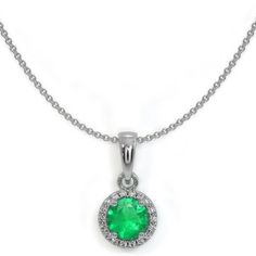 A vibrant Round Emerald measuring 5.00 x 5.00 x 3.20mm with minor clarity enhancement. It is encircled with VS2 White Diamonds that have no enhancement in an 18k White Gold setting. Luxury Classic Round Emerald Necklace, Luxury Emerald Necklace With Brilliant Cut, Classic Halo Setting Jewelry For May Birthstone, Classic Jewelry With Halo Setting For May Birthstone, Formal Round Emerald Necklace Fine Jewelry, Formal Round Emerald Necklace, Classic Emerald Necklace With Brilliant Cut Cubic Zirconia, Classic Diamond Cut Emerald Necklace, Classic Silver Emerald Necklace With Brilliant Cut