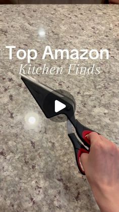 a person holding scissors on top of a counter with the words top amazon kitchen finds