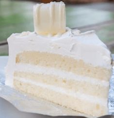 a slice of white cake sitting on top of a piece of tin foil covered plate