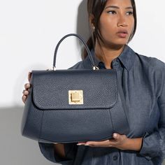 The Arcadia Bernadette is a satchel with geometric and sharp lines. It’s elegant and classy thanks to the macro front turn lock. It comes with a sholder strap for an extra comfort. Luxury Everyday Shoulder Bag With Turn-lock Closure, Luxury Flap Bag With Turn-lock Closure For Daily Use, Elegant Satchel With Top Handle And Fold Over Clasp, Office Flap Bag With Palladium Hardware And Top Handle, Office Flap Bag With Top Handle And Palladium Hardware, Elegant Top Handle Satchel With Fold Over Clasp, Luxury Shoulder Bag With Fold Over Clasp For Work, Luxury Everyday Satchel Shoulder Bag With Turn-lock Closure, Luxury Office Flap Bag With Turn-lock Closure