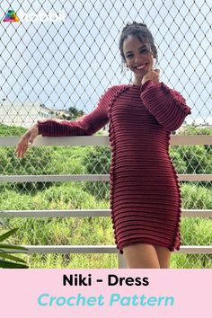 a woman standing next to a fence wearing a red dress