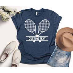 a t - shirt that says custom text with two tennis rackets