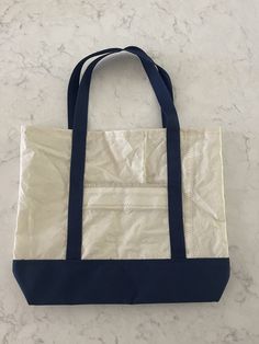 16" by 10" navy blue recycled sail tote bag with front pocket. crosslisted- message for details Navy Casual Canvas Bag With Large Capacity, Casual Navy Canvas Bag With Large Capacity, Casual Navy Canvas Tote Bag, Navy Canvas Tote Bag, Navy Cotton Tote Bag, Nautical Navy Bag For Everyday Use, Nautical Canvas Bags For Everyday Use, Nautical Style Navy Bag For Everyday Use, Navy Rectangular Canvas Bag