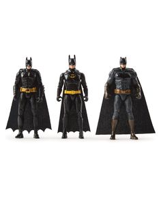 three batman action figures standing next to each other