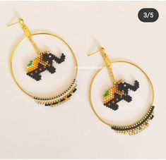 a pair of hoop earrings with beaded elephant on the hoop and beads hanging from it