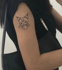 a woman with a cat tattoo on her arm