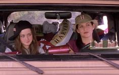 two women sitting in the back of a truck