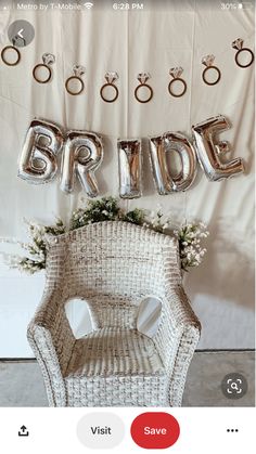 a chair with balloons and flowers on it in front of a sign that says bride