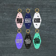 six different colored key chains with words on them