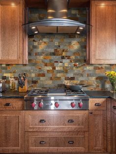 a stove top oven sitting inside of a kitchen next to wooden cabinets and counter tops