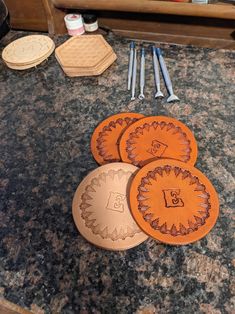 three wooden coasters sitting on top of a counter next to other crafting supplies