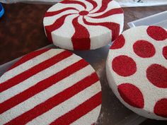 three red and white candy canes sitting on top of a counter next to scissors