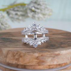 a diamond ring sitting on top of a wooden table