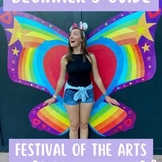 a woman standing in front of a colorful butterfly with the words festival of the arts on it