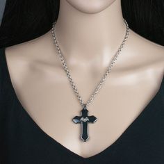 "Add a touch of traditional gothic style to your wardrobe with this cross pendant necklace. It would make a great addition to any dark jewelry collection! 💀 DESCRIPTION: This pendant necklace features a large cross made from hematite that was adorned with a small bat stamping. The cable chain was finished with a lobster clasp. 💀 SIZE & MATERIALS: The stamping was made from oxidized sterling silver plated brass. The chain was made from stainless steel and measures 18\" long. If you would li Traditional Goth, Bat Pendant, Necklace Traditional, Dark Jewelry, Hematite Stone, Goth Jewelry, Wing Necklace, Halloween Accessories, Black Chain