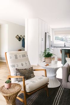 a living room filled with furniture and a potted plant