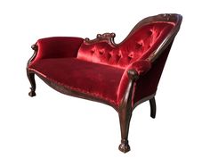 an old fashioned red velvet chair with ornate carvings