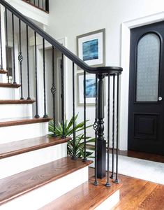 a black door and some stairs in a house