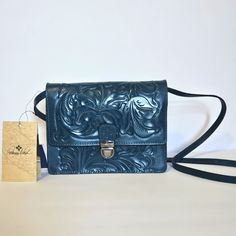 Patricia Nash Laurentina Blue Coral Crossbody Bag. New With Tags. 100% Full-Grain Leather - Burnished Tooled Colors Collection - Adjustable Crossbody Strap - 22" Drop - Flap With Patch Clasp Closure - Signature Brushed Silver Hardware - Faux Suede Lining - Dimensions: 9"(W) X 7"(H) X 3"(D) Blue Crossbody Saddle Bag For Daily Use, Luxury Blue Satchel As Gift, Elegant Blue Shoulder Bag With Cell Phone Pocket, Blue Crossbody Saddle Bag With Removable Pouch, Blue Rectangular Saddle Bag With Detachable Strap, Blue Saddle Shoulder Bag, Blue Satchel Saddle Bag With Removable Pouch, Blue Saddle Bag Satchel With Removable Pouch, Blue Saddle Bag With Removable Pouch