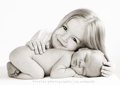 a black and white photo of two babies