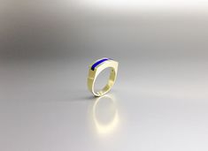 Modern ring blue Lapis Lazuli with solid 18K gold. Unique gift for her, wife, girlfriend, September and December birthstone, 9 year anniversary. Embedded in the 18K gold, the blue Lapis Lazuli gives this ring a modern design. This beautiful ring is worked with the technique of inlay, which means the stone is worked seamlessly into the 18K gold. All our stones are natural stones and our jewelry is handmade, slight differences in color and size may occur. Our inlay work is made with real stone and Modern Gold Signet Ring With Birthstone, Modern Blue Sapphire Ring In 14k Gold, Sapphire 14k Gold Signet Ring Gift, Elegant Blue Gemstone Signet Ring, 14k Gold Sapphire Signet Ring As Gift, Modern Blue Sapphire Ring Hallmarked, Modern Blue Oval Signet Ring, Luxury Blue Ring With Tension Setting, Minimalist Sapphire Ring With Polished Finish For Formal Events