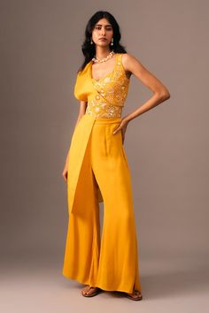 Mustard top with thread, bead, sequin embroidery in floral pattern. Paired with flared pant and drape. - Aza Fashions Hand Embellished Sleeveless Party Wear Set, Bollywood Style Sleeveless Hand Embellished Sets, Bollywood Hand Embellished Sleeveless Sets, Glamorous Summer Sleeveless Set, Glamorous Sleeveless Summer Sets, Silk Pant Set With Zari Work For Party, Hand Embellished Fitted Palazzo Set For Party, Sleeveless Designer Blouse For Party Wear, Sleeveless Party Wear Blouse For Designer Wear