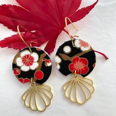 "About the earrings: These art deco earrings are made with a luscious, black, red and white chiyogami paper. This Japanese paper is hand-printed using the silk-screen technique. In this laborious process each color is applied using a separate screen. Sometimes as many as 12 colors, including gold or other metallics, may be used to create a single pattern. Often inspired by textile and kimono patterns which include symbolic and seasonal motifs, designers of chiyogami continue to expand the options. In these paper earrings, the cherry blossoms are a symbol for the fleeting nature of life. The brass component adds a \"art deco\" look that I love in these elegant looking paper earrings. Since these earrings are hand made, each set of earrings is different and unique! While they'll be made from Black Retro Handmade Jewelry, Retro Black Handmade Jewelry, Elegant Black Dangle Flower Earrings, Black Retro Earrings, Black Dangle Flower Earrings With Ear Wire, Unique Handmade Black Earrings, Vintage Black Enamel Earrings For Gifts, Vintage Black Dangle Earrings, Black Flower Drop Earrings For Gift