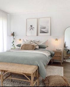 a bedroom with a bed, dresser and two framed pictures on the wall above it