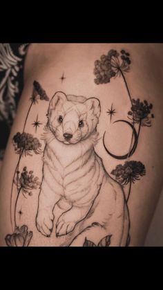 a black and white photo of a bear with flowers on it's back leg