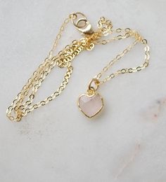 Looking for a unique accessory for some self love, or love for that special someone? Crafted from 14k gold filled and natural Rose Quartz, this pendant is the perfect, sparkling way to show anyone how much you care. Rose Quartz is a stone of love. It is believed to restore trust & harmony in relationships and encourage unconditional love. It purifies the heart and promotes self love, inner healing, and friendship. It is an alternate birthstone for January, as well as the spiritual birthstone for Rose Gold Birthstone Heart Necklace For Valentine's Day, Valentine's Day Rose Gold Heart Necklace With Birthstone, Pink Gold Heart Charm Pendant Jewelry, Feminine Jewelry With Delicate Chain As Gift, Tiny Heart Pendant Jewelry For Valentine's Day, Delicate Heart Shaped Jewelry Gift For Her, Feminine Pendant Jewelry Gift, Delicate Heart-shaped Jewelry Gift For Her, Feminine Delicate Chain Jewelry As Gift