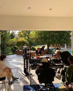 a group of people sitting around a table with speakers