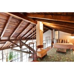 a bedroom with wooden ceilings and green carpet