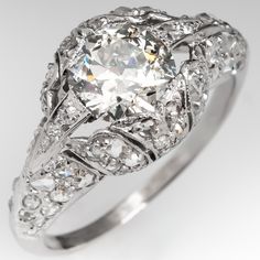 an antique style diamond engagement ring with filigrees