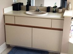 a bathroom with a blue rug on the floor next to a sink and counter top